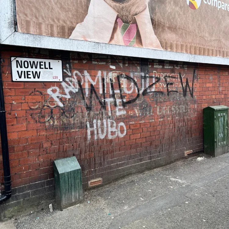 Brick wall in Harehills covered in spray paint graffiti